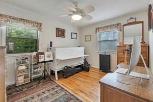 Bedroom/office featuring wood finished floors and ceiling fan