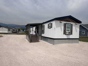 View of front facade featuring cooling unit and a mountain view