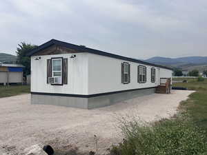 View of side of home with a mountain view