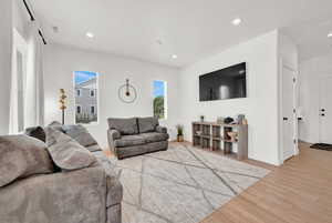 Living area featuring recessed lighting, light wood-type flooring, and baseboards