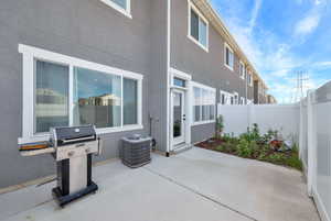 View of patio featuring area for grilling  and a fenced backyard