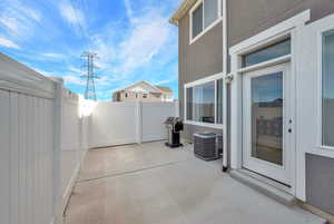 View of patio and a fenced backyard