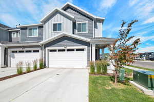 View of front of house with concrete driveway, a garage, and board and batten siding