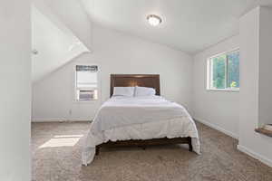 Bedroom featuring lofted ceiling, carpet floors, and cooling unit