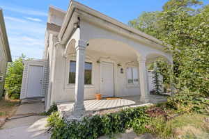View of front facade featuring stucco siding and a porch