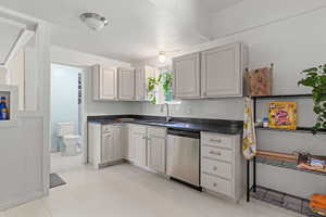 Kitchen with dishwasher and light tile patterned floors