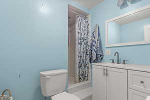 Full bath featuring vanity and a tile shower