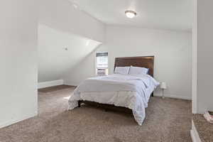 Bedroom featuring carpet floors, lofted ceiling, and cooling unit