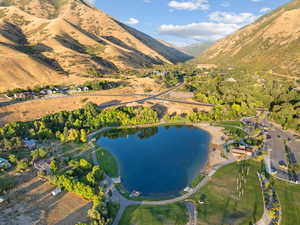 Birds eye view of property featuring a water and mountain view