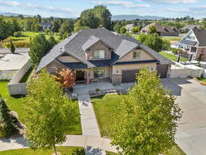 View of front of home featuring stucco siding, a fenced backyard, driveway, and a gate