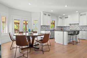 Dining room featuring recessed lighting, a healthy amount of sunlight, french doors, and light wood-style floors