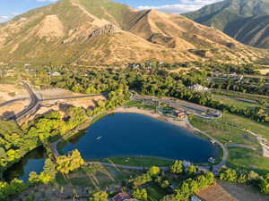 Birds eye view of property with a water and mountain view