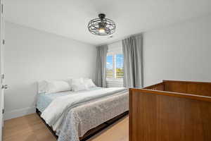 Bedroom featuring light wood finished floors and baseboards