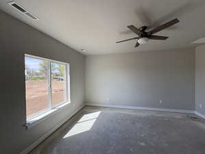Unfurnished room featuring baseboards, visible vents, concrete floors, and ceiling fan