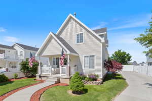 View of front of home with covered porch and concrete driveway