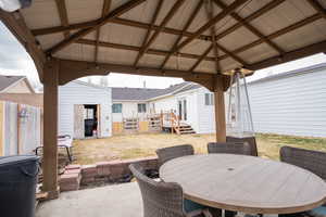 View of patio / terrace featuring a gazebo, outdoor dining area, and fence