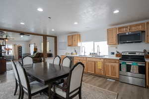 Interior space featuring recessed lighting, a textured ceiling, ceiling fan, and light wood finished floors