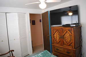 Bedroom featuring a ceiling fan and a closet