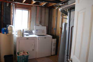 Laundry area featuring separate washer and dryer and laundry area