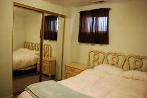 Bedroom featuring visible vents, carpet, and a closet