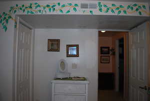 Bathroom featuring visible vents and a textured ceiling