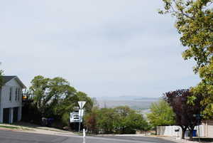 View of road with a mountain view, sidewalks, and curbs