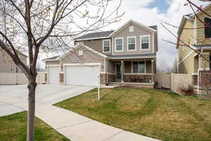 View of front of house with a front yard, a gate, concrete driveway, and fence