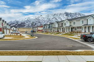 View of road featuring a residential view, a mountain view, street lighting, and sidewalks