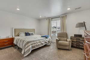 Bedroom with recessed lighting, visible vents, and carpet floors