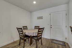 Dining space with baseboards and wood finished floors
