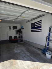 Garage with electric panel and a garage door opener