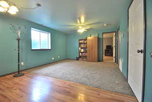 Interior space featuring a ceiling fan and wood finished floors