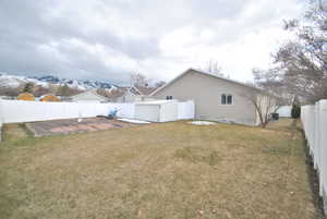 View of yard featuring a mountain view, a garden area, and a fenced backyard.  Property has secondary irrigation water.