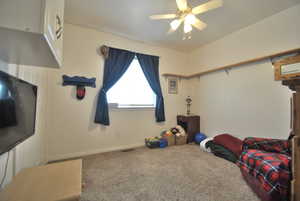 Bedroom with visible vents, a ceiling fan, and carpet