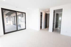 Carpeted empty room featuring recessed lighting and baseboards