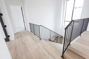 Stairway featuring wood-type flooring