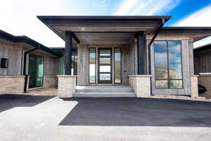 Doorway to property with stone siding