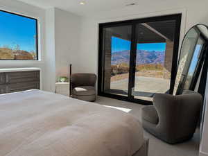 Bedroom featuring carpet flooring, access to exterior, recessed lighting, and a mountain view