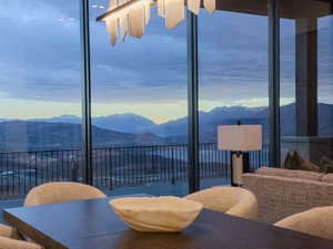 Dining room featuring a mountain view and a wall of windows