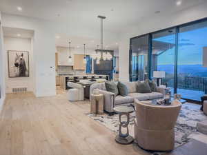 Living area with a mountain view, light wood-style floors, and recessed lighting