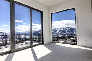 Empty room featuring carpet flooring and a mountain view