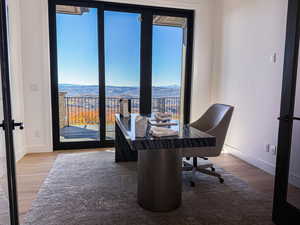Office area featuring light wood finished floors and a mountain view