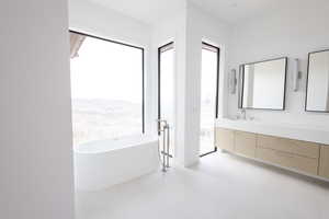 Full bath featuring a soaking tub and vanity