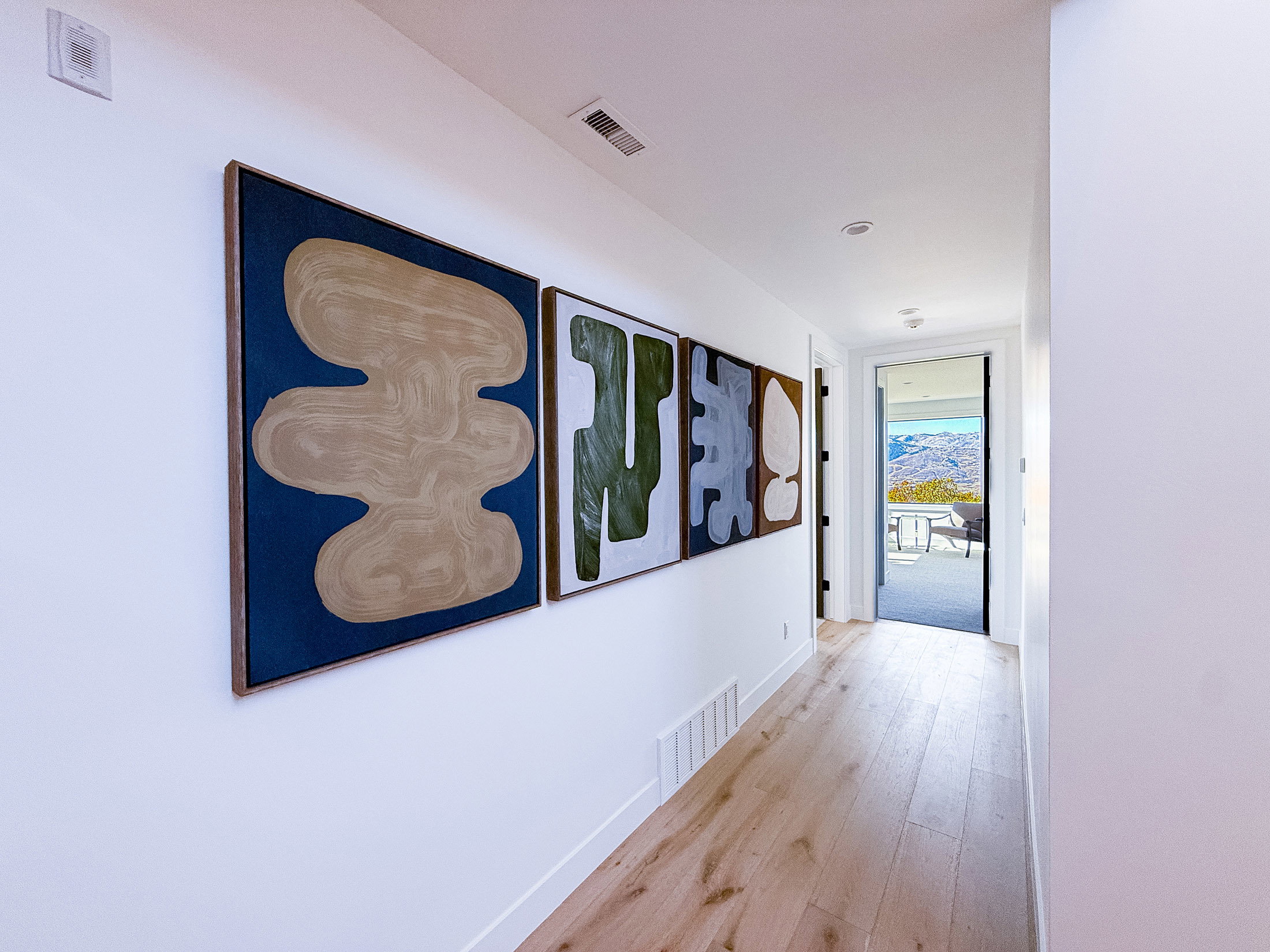 Hallway featuring wood finished floors and baseboards