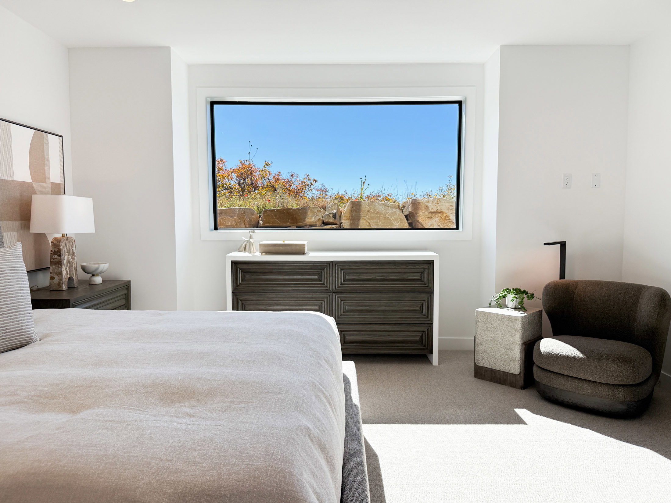 Carpeted bedroom featuring multiple windows