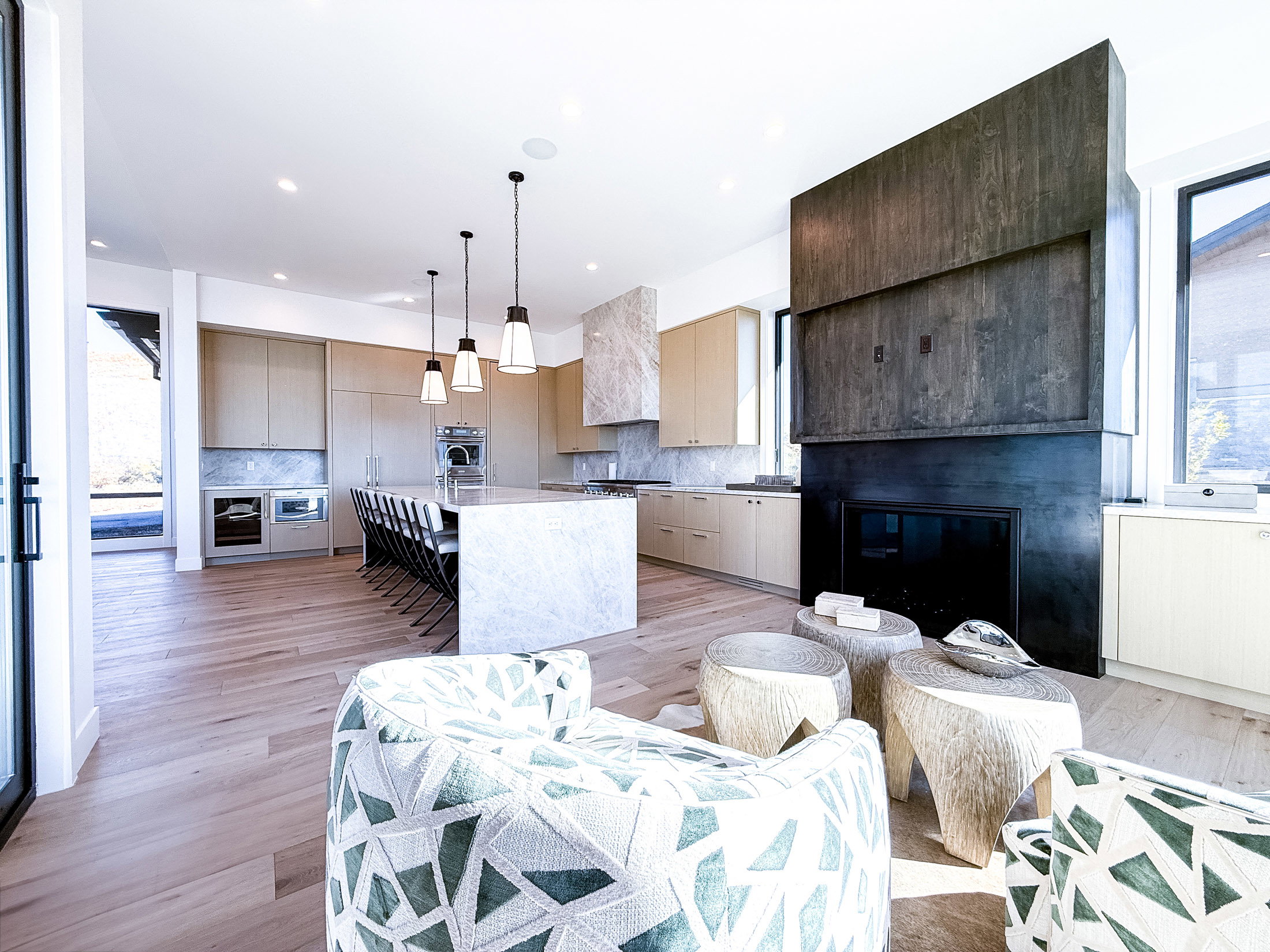 Kitchen featuring pendant lighting, an island with sink, modern cabinets, healthy amount of natural light, and recessed lighting