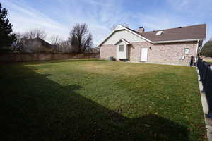 View of yard featuring central AC and a fenced backyard
