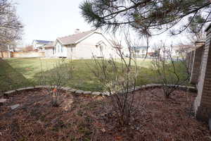 View of yard featuring fence and a residential view
