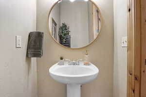Bathroom with a textured wall and a sink