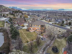 Aerial view at dusk featuring a mountain view and a residential view